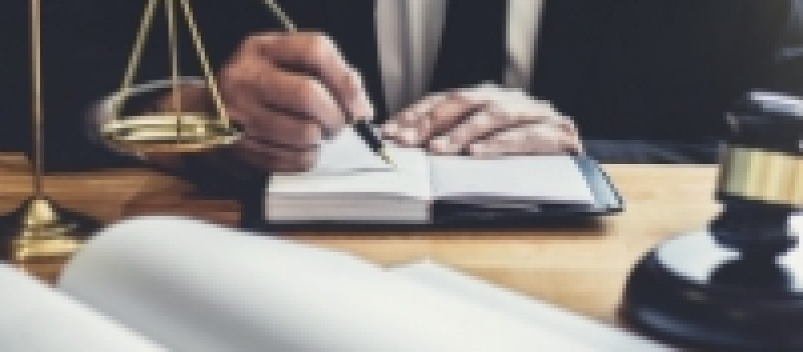 male-lawyer-or-judge-working-with-contract-papers-5ZV28KL.jpg