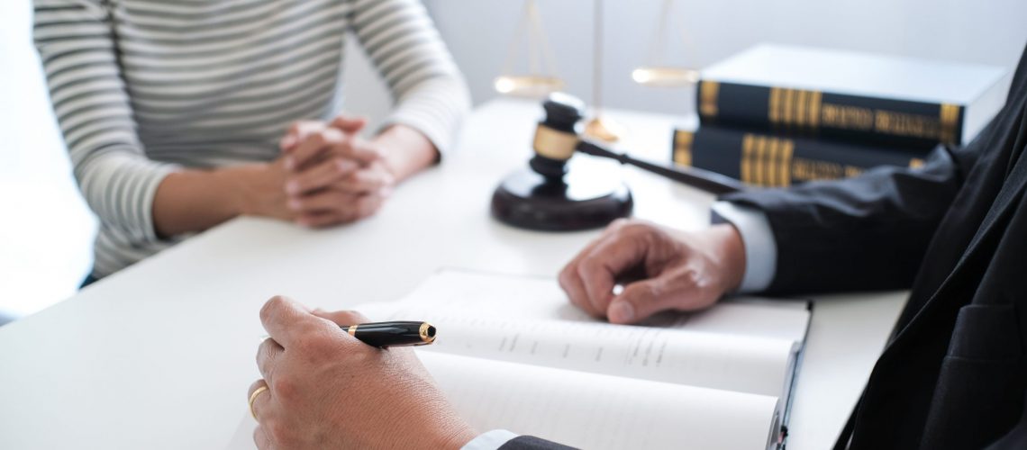 Legal counsel presents to the client a signed contract with gavel and legal law. justice and lawyer concept